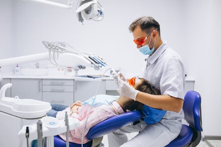 Dentist treating a patient in the dental chair